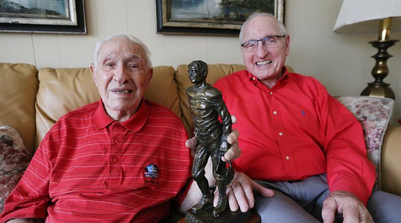 Georgia legends Charley Trippi, 96, with his Rose Bowl Hall of Fame trophy, and Vince Dooley, 85, share a laugh at the Trippi home on Thursday, Dec. 21, 2017, in Athens.