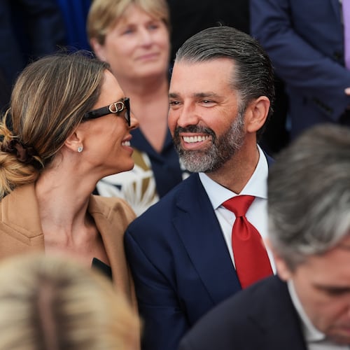 Donald Trump Jr, center, speaks with his wife Bettina, left, as they wait for U.S. President Donald Trump to deliver remarks to U.S. embassy staff at Deerfield Residence in Dublin, Saturday, Sept. 12, 2026. (AP Photo/Julia Demaree Nikhinson)