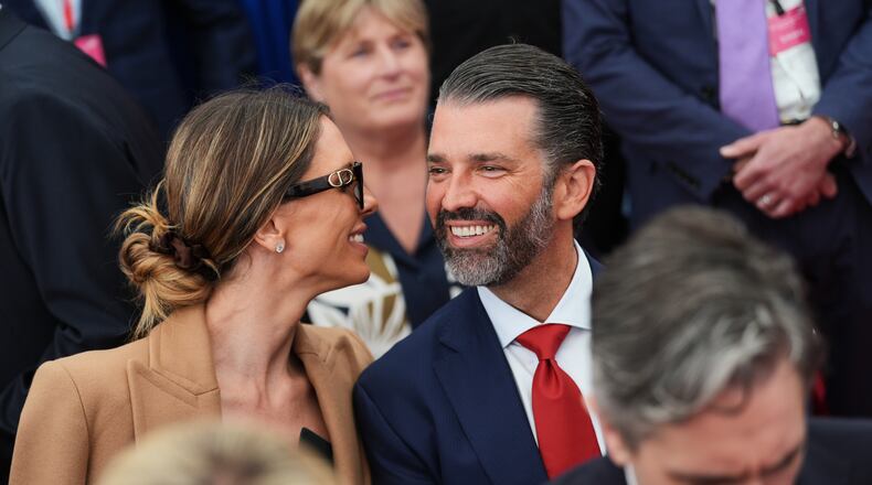 Donald Trump Jr, center, speaks with his wife Bettina, left, as they wait for U.S. President Donald Trump to deliver remarks to U.S. embassy staff at Deerfield Residence in Dublin, Saturday, Sept. 12, 2026. (AP Photo/Julia Demaree Nikhinson)