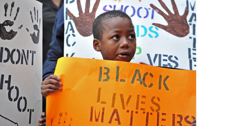 Marquise Miller, 8, who came with his mother, holds a sign outside Marietta Municipal Court during a peaceful demonstration Dec. 6 against decisions not to indict white police officers in the deaths of unarmed black men in Ferguson, Mo., and in New York City.