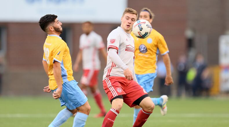 Atlanta United midfielder Julian Gressel fights for the ball with a Chattanooga midfielder. (Miguel Martinez)