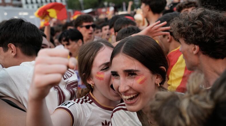 Spanish fans celebrate in central Madrid after Spain's Mikel Oyarzabal scores the opening goal on a penalty kick during the World Cup semifinal soccer match between France and Spain in Arlington, Texas, near Dallas, Tuesday, July 14, 2026. (AP Photo/Bernat Armangue)
