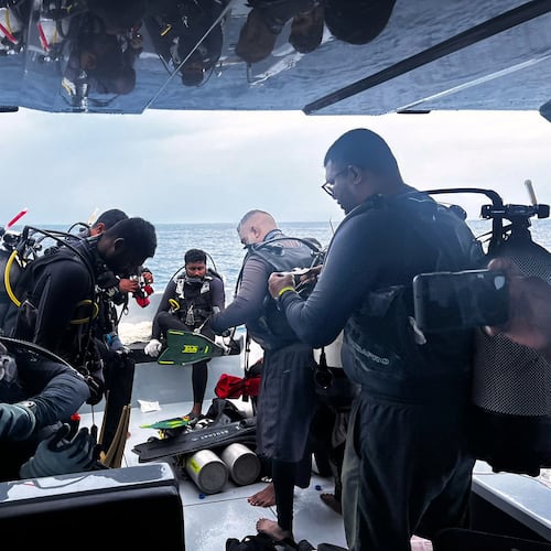 This image released by the Maldives President's Media Division, shows divers preparing to search for the four missing Italian divers near Alimathaa Island, Vaavu Atoll, Maldives, Saturday, May 15, 2026. (Maldives President's Media Division via AP)