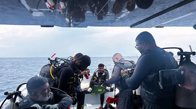 This image released by the Maldives President's Media Division, shows divers preparing to search for the four missing Italian divers near Alimathaa Island, Vaavu Atoll, Maldives, Saturday, May 15, 2026. (Maldives President's Media Division via AP)