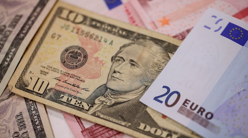 A U.S. ten dollar bills sits among ten and twenty euro banknotes in this arranged photograph taken inside a Travelex store, operated by Travelex Holdings Ltd., in London, U.K., on Monday, Jan. 12, 2015. Photographer: Simon Dawson/Bloomberg
