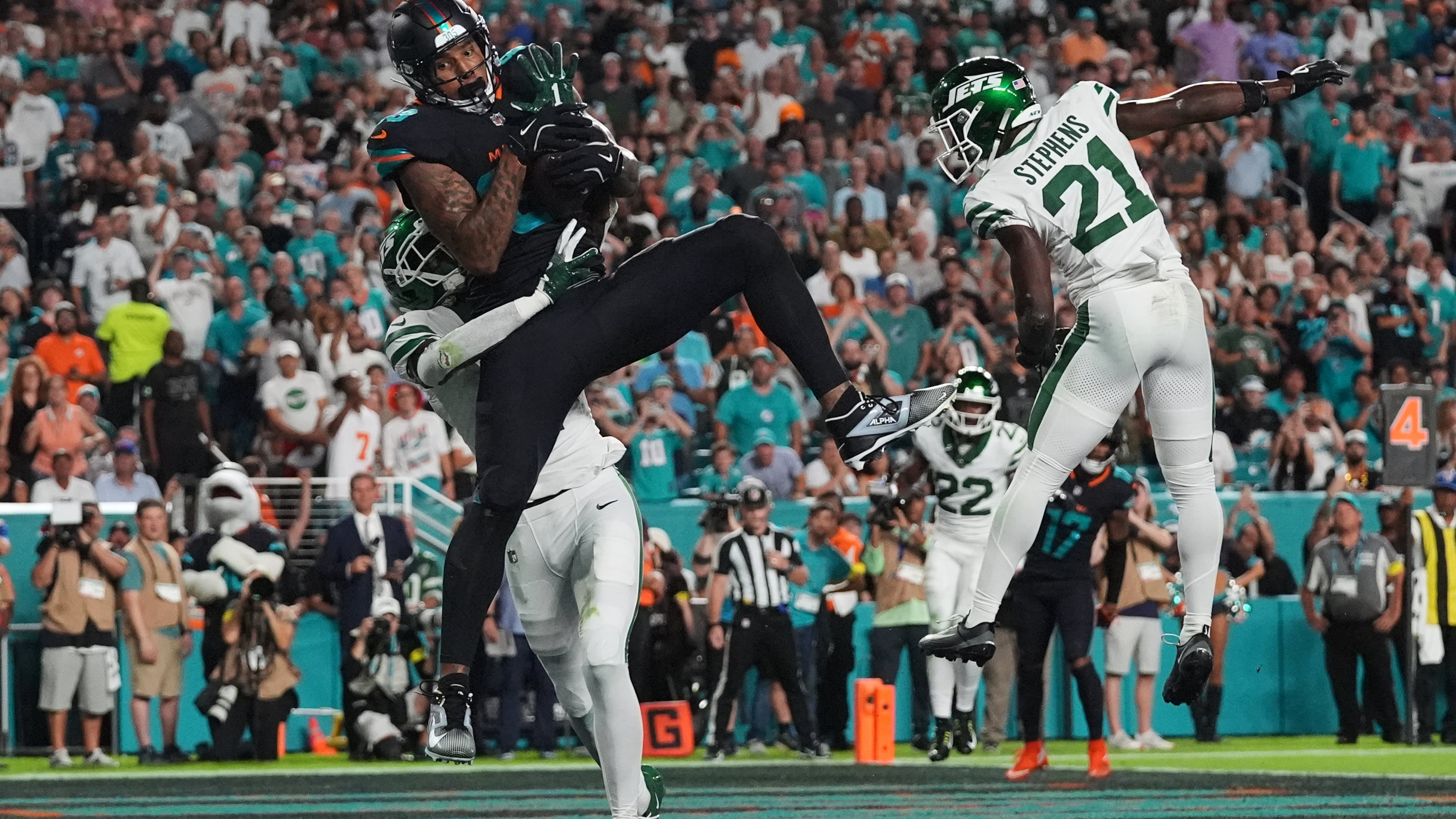 Miami Dolphins tight end Darren Waller (83) catches a touchdown pass as New York Jets' Sauce Gardner, rear, and Brandon Stephens (21) defend in the first half of an NFL football game, Monday, Sept. 29, 2025, in Miami Gardens, Fla. (AP Photo/Marta Lavandier)