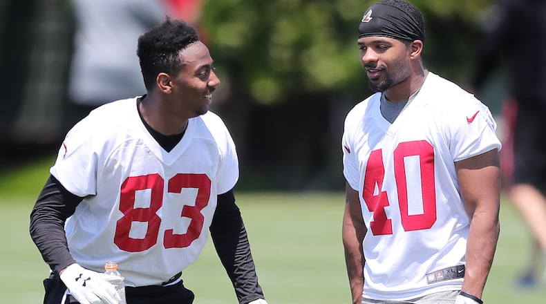 Falcons wide receiver Russell Gage (left) shares a laugh with safety Tere Calloway after the first day of rookie minicamp on Friday, May 11, 2018, in Flowery Branch.  Curtis Compton/ccompton@ajc.com