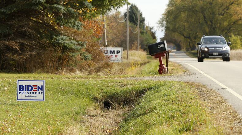 Neighboring Biden and Trump signs are shown along County Highway A in Somers, Wisconsin, on Oct. 21, 2020. (Stacey Wescott/Chicago Tribune/TNS)