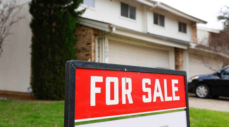 A for sale sign is displayed outside a house in Carrollton, Texas. (Shafkat Anowar/The Dallas Morning News/TNS)