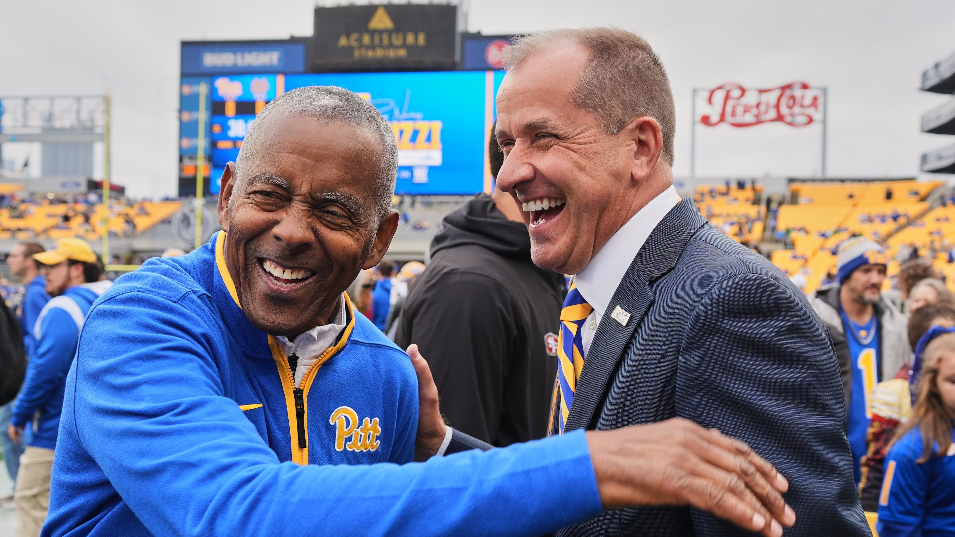 ACC Commissioner James J. Phillips, right, visits on the field with Hall of Fame running back Tony Dorsett before an NCAA college football game between Pittsburgh and Notre Dame in Pittsburgh Saturday, Nov. 15, 2025. (AP Photo/Gene J. Puskar)