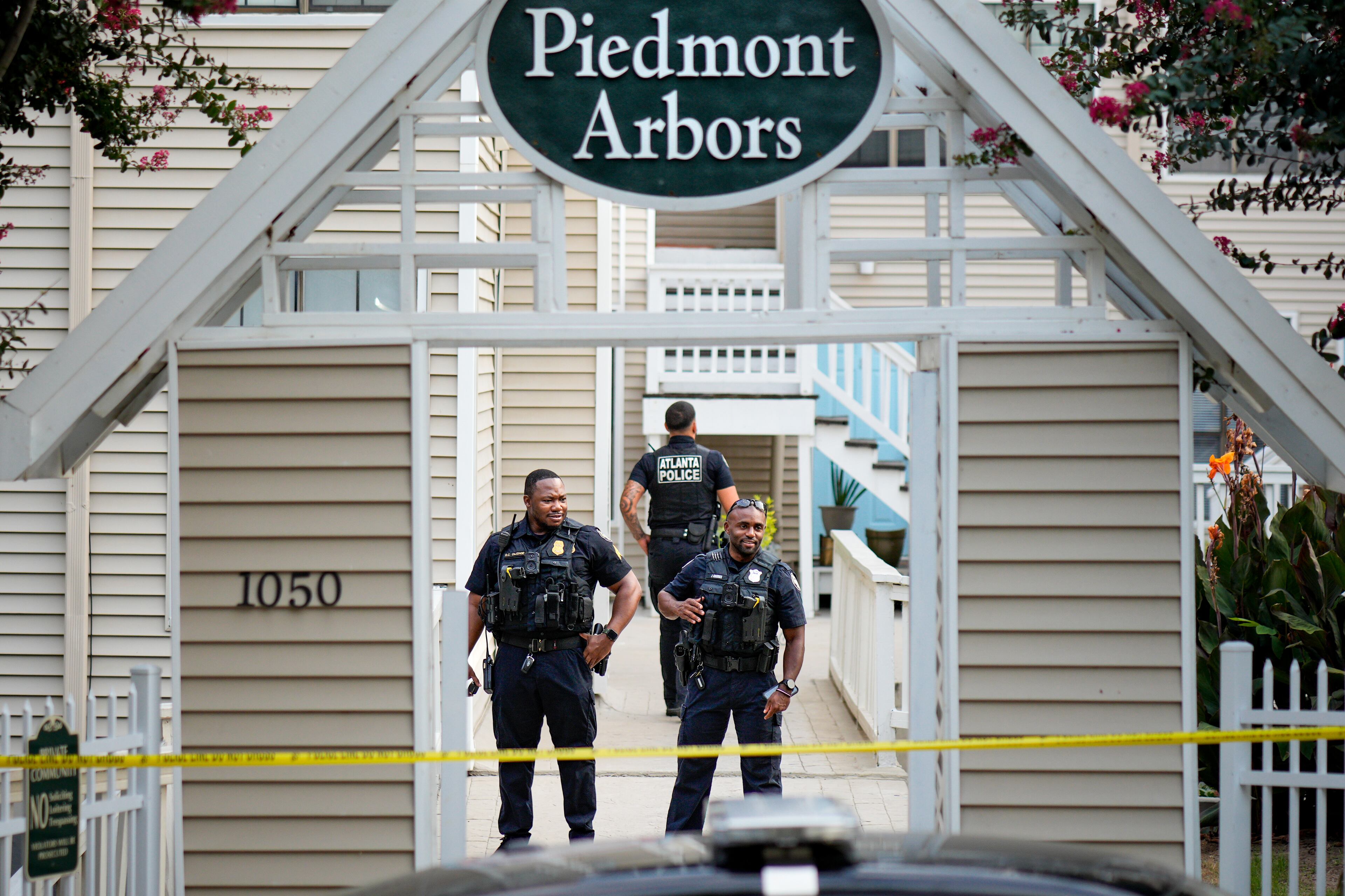 Investigators had crime scene tape strung up across at least one of the entrances to the community as they combed for evidence. (Ben Hendren for the AJC)