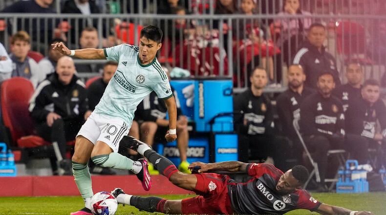 Atlanta United midfielder Luiz Araujo (10) plays the ball against Toronto FC midfielder Mark-Anthony Kaye during the first half of an MLS soccer match Saturday, April 15, 2023, in Toronto. (Andrew Lahodynskyj/The Canadian Press via AP)