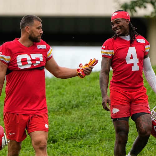 Kansas City Chiefs tight end Travis Kelce (87), and wide receiver Rashee Rice (4) walk to NFL football training camp Friday, July 31, 2026, in St. Joseph, Mo. (AP Photo/Charlie Riedel)