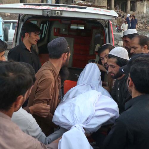 People place the body of a miner recovered after an explosion inside a coal mine, into an ambulance on the outskirts of Quetta, in southwest Pakistan, Thursday, July 30, 2026. (AP Photo/Fazal Tawab)
