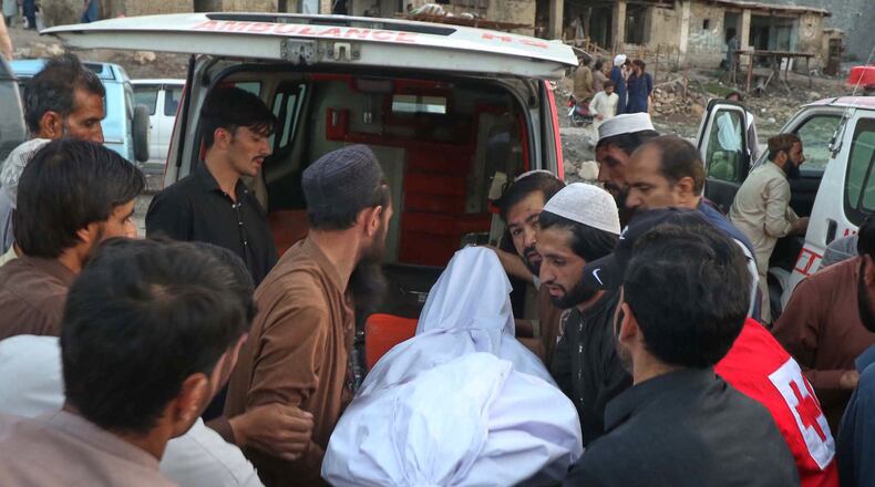 People place the body of a miner recovered after an explosion inside a coal mine, into an ambulance on the outskirts of Quetta, in southwest Pakistan, Thursday, July 30, 2026. (AP Photo/Fazal Tawab)