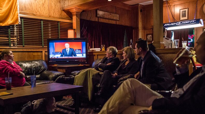 Members of the Dallas County GOP watch the Republican presidential debate at Mickey's Irish Pub on Thursday in Waukee, Iowa. Brendan Hoffman/Getty Images