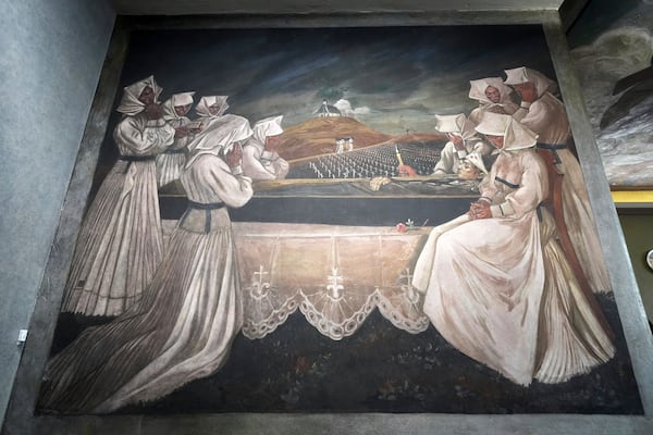 A mural by Croatian-American artist Maxo Vanka titled "Croatian Mother Raises Her Son for War" is displayed inside St. Nicholas Croatian Catholic Church in Millvale, Pa., Tuesday, March 18, 2025. (AP Photo/Gene J. Puskar)
