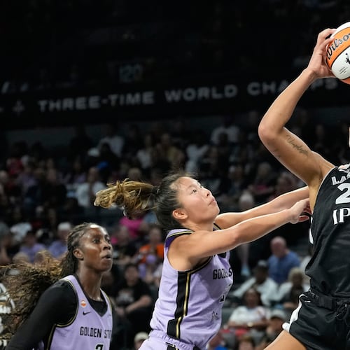 Las Vegas Aces center A'ja Wilson (22) grabs a rebound over Golden State Valkyries guard Kaitlyn Chen (2) during the second half of a WNBA basketball game Sunday, June 21, 2026, in Las Vegas. (AP Photo/John Locher)