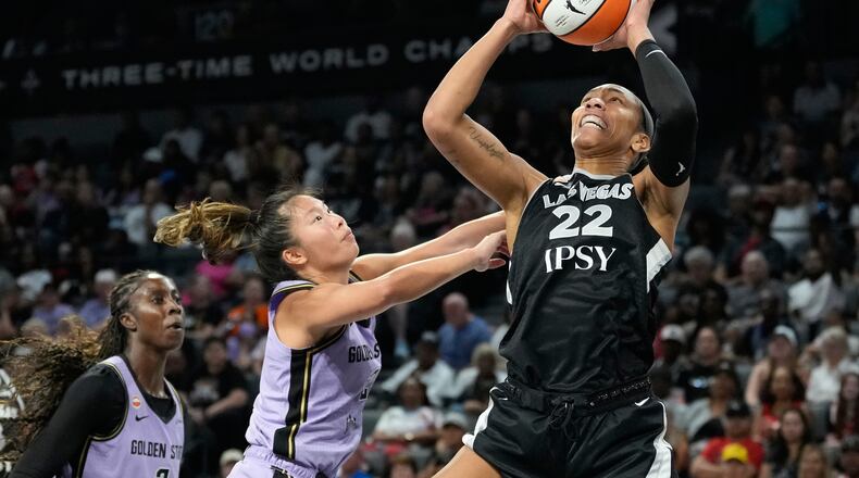 Las Vegas Aces center A'ja Wilson (22) grabs a rebound over Golden State Valkyries guard Kaitlyn Chen (2) during the second half of a WNBA basketball game Sunday, June 21, 2026, in Las Vegas. (AP Photo/John Locher)