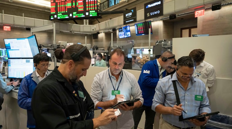Options traders Chris Dattolo, Scott Frinzi, and Ravi Bhandari, left to right, work on the floor of the New York Stock Exchange, Monday, Aug. 17, 2026, in New York. (AP Photo/Yuki Iwamura)