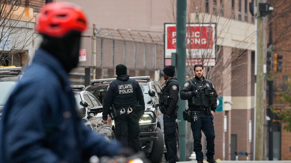 Atlanta police officers assist with the search for Rockdale County escaped inmate Timothy Shane. He is accused of running from Grady Memorial Hospital on Monday. (Ben Hendren for the AJC)