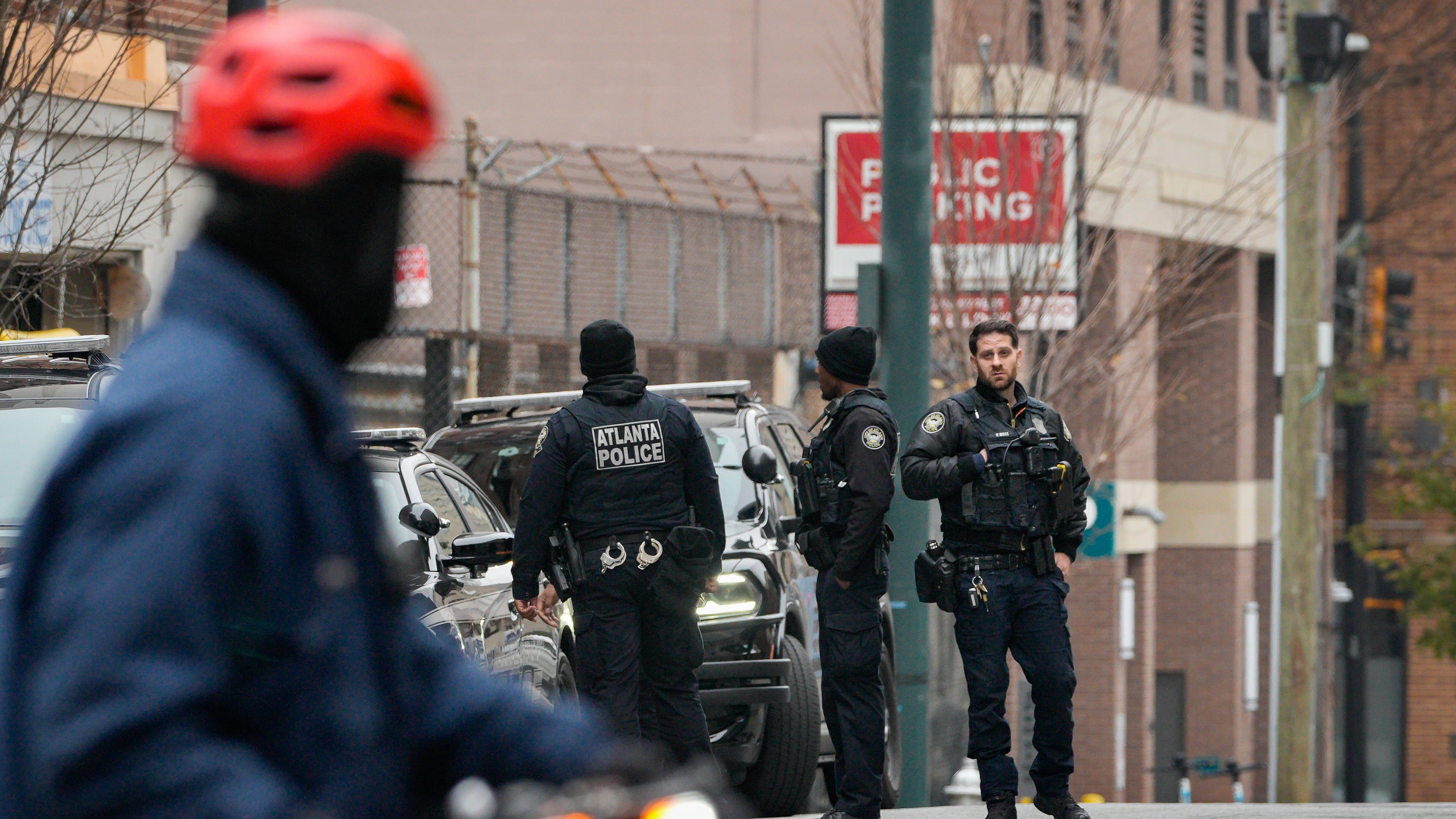 Atlanta police officers offer an early assist with the search for Rockdale County escaped inmate Timothy Shane, who ran away from Grady Memorial Hospital on Monday, Dec. 1, 2025. (Ben Hendren for the AJC)