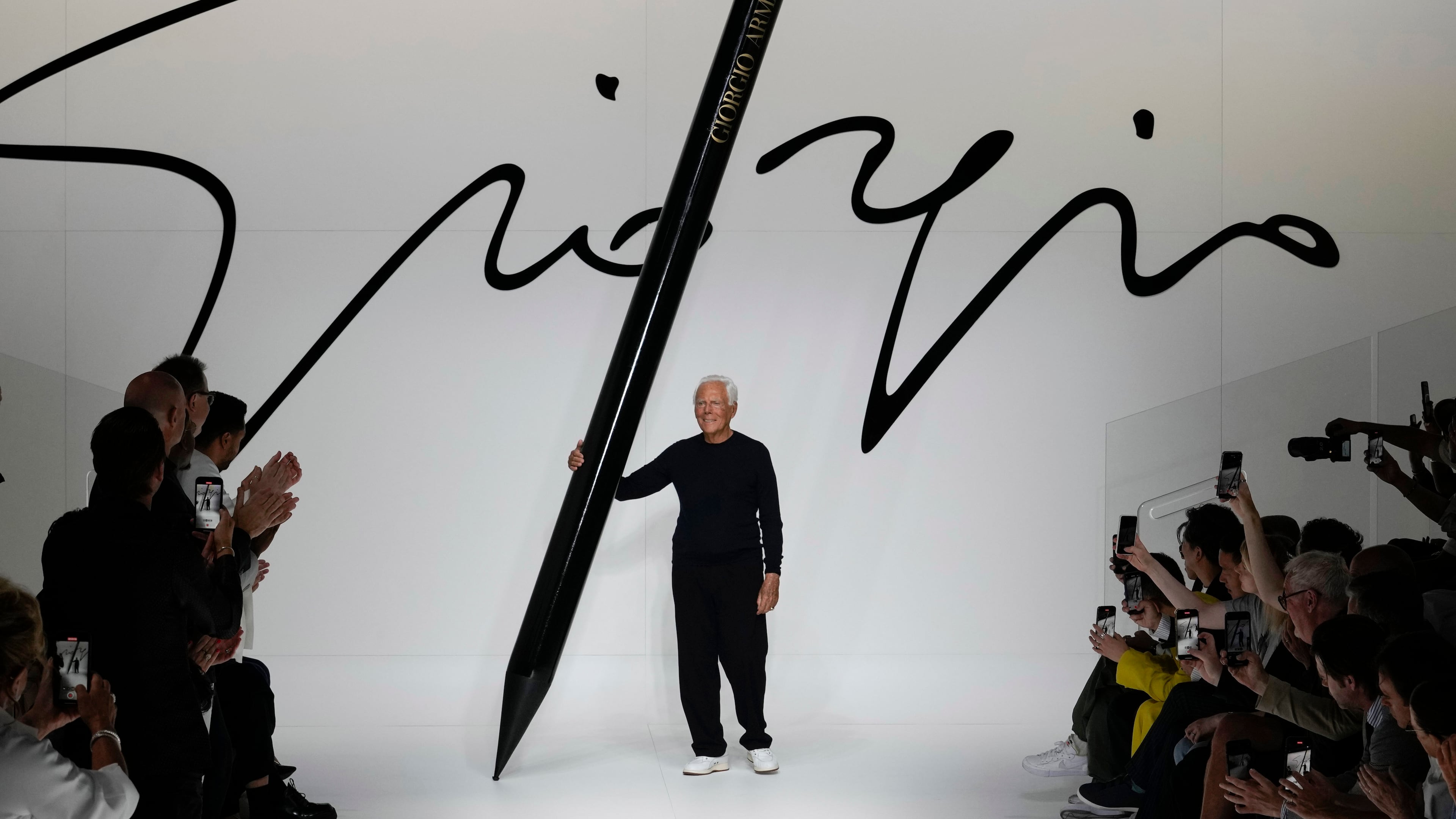 FILE -Designer Giorgio Armani receives applause at the end of the Giorgio Armani men's Spring Summer 2024 fashion show presented in Milan, Italy,, June 19, 2023. (AP Photo/Luca Bruno, File)