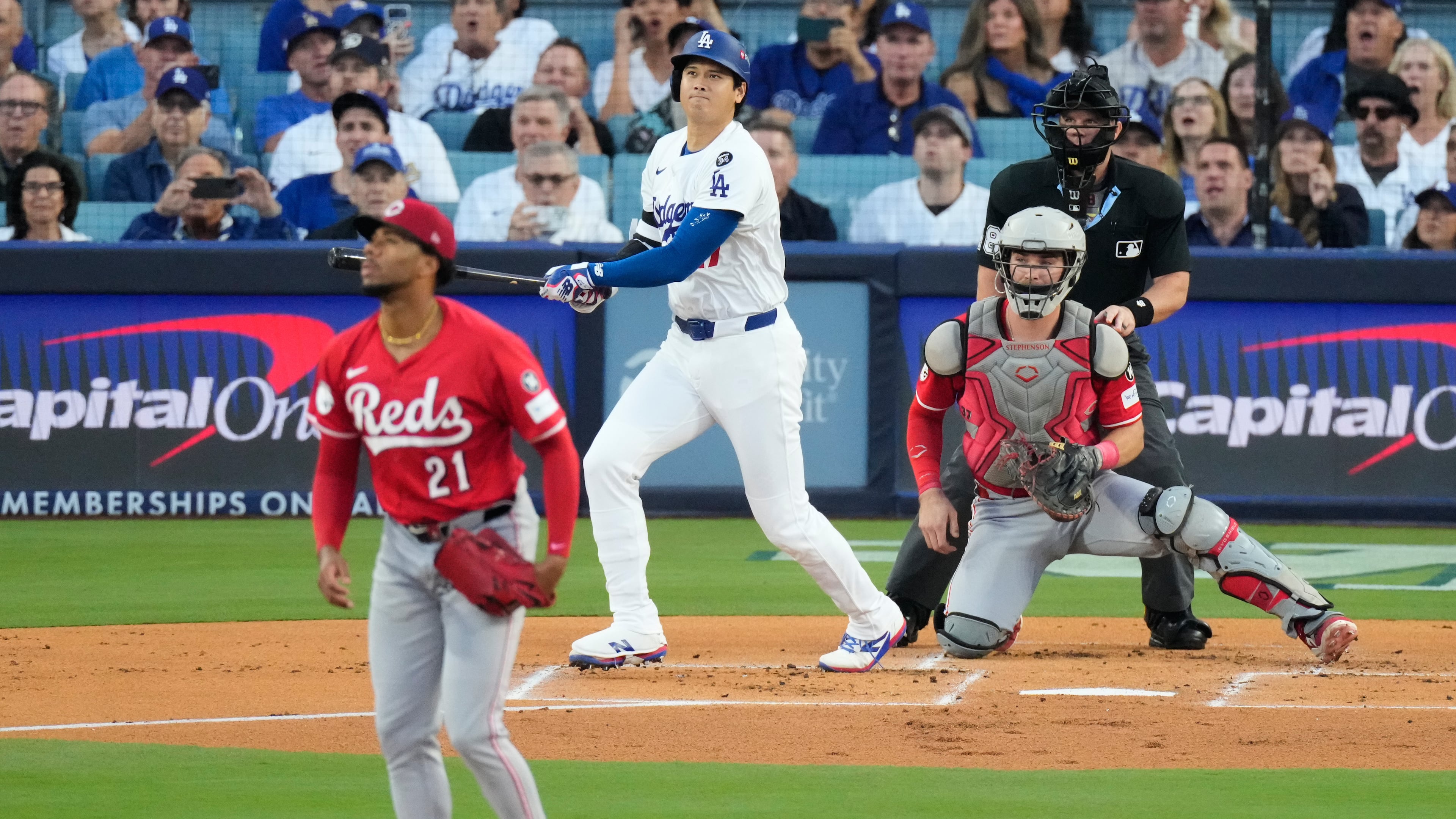 Los Angeles Dodgers' Shohei Ohtani watches his solo home run off Cincinnati Reds starting pitcher Hunter Greene (21) during the first inning in Game 1 of the National League Wild Card baseball playoff series Tuesday, Sept. 30, 2025, in Los Angeles. (AP Photo/Mark J. Terrill)