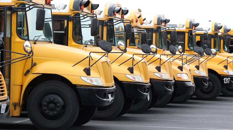Buses are lining up to pick up students next week. Some Georgia schools resume Monday. (AJC File)