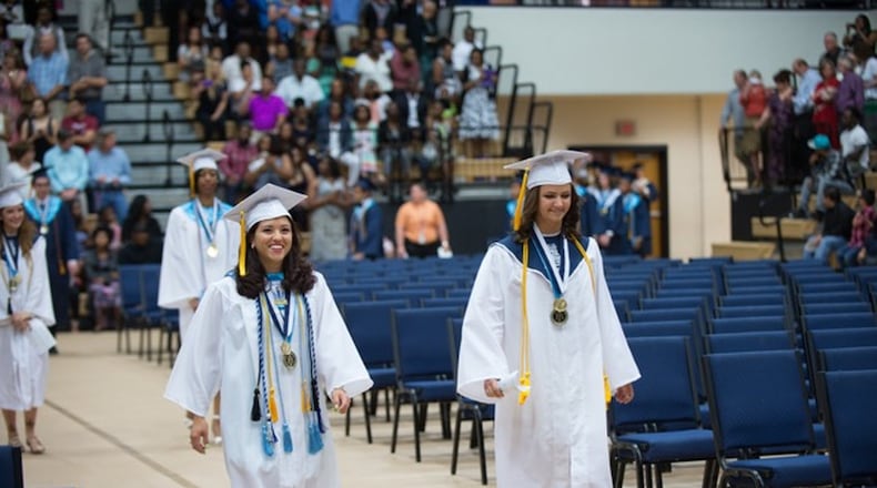 International Baccalaureate graduate Juanita Londono (left), shown at this year’s Marietta High School graduation, was a member of the National Honor Society, the Math Honor Society, the Beta Club and the Kitty Hawk Honor Society and was a varsity cross country and track athlete. CONTRIBUTED BY JOHNNY WALKER