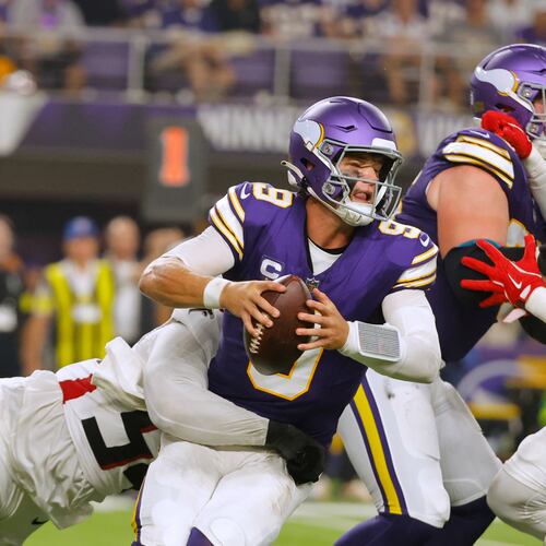 Atlanta Falcons defensive tackle Brandon Dorlus (left) sacks Minnesota Vikings quarterback J.J. McCarthy during the first half of an NFL football game, Sunday, Sept. 14, 2025, in Minneapolis. (Bruce Kluckhohn/AP)