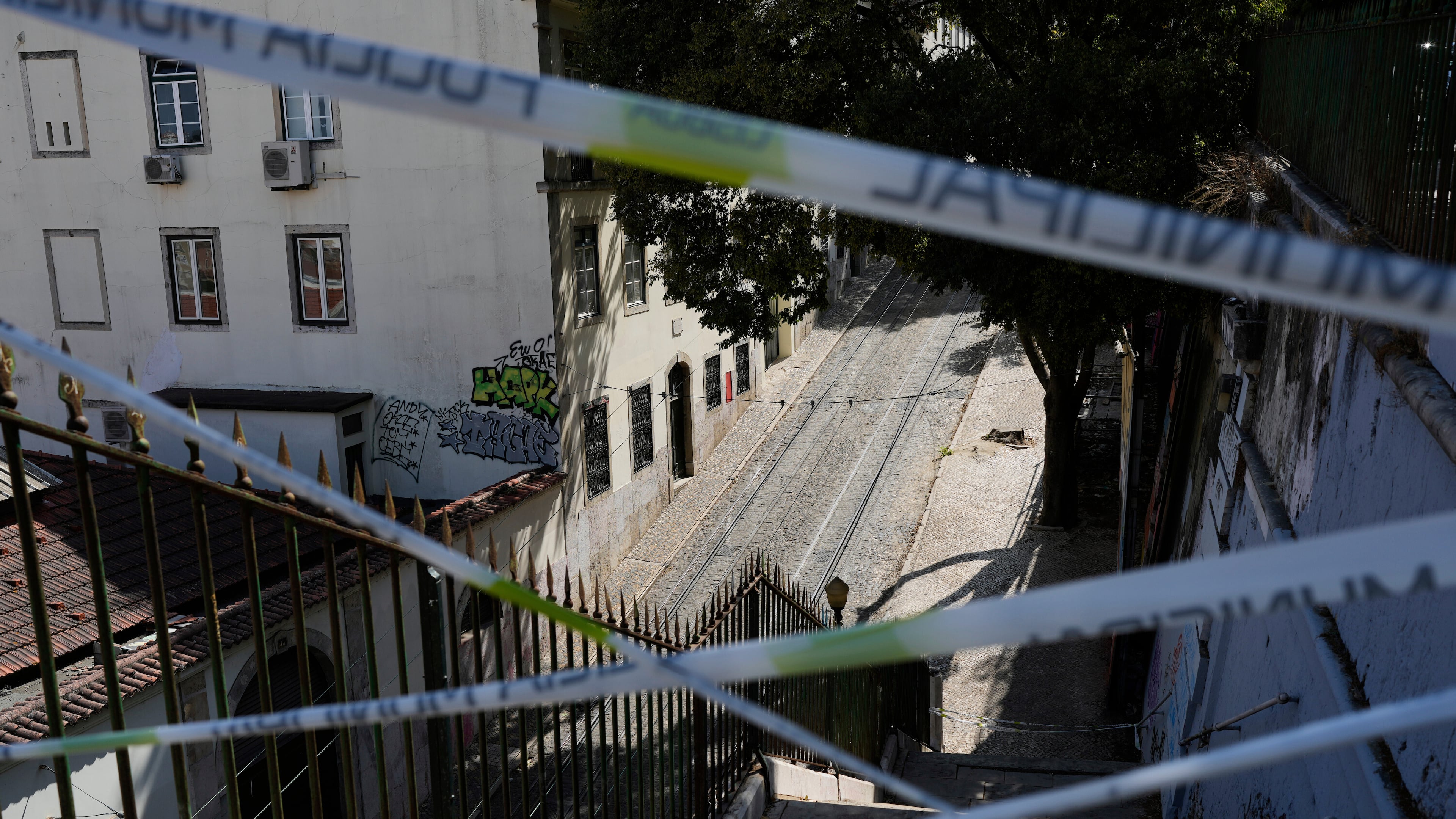 FILE - Police tape cordons-off the access to the tracks of the Gloria funicular, a tourist streetcar that derailed and crashed, in Lisbon, Sept. 5, 2025. (AP Photo/Armando Franca, File)