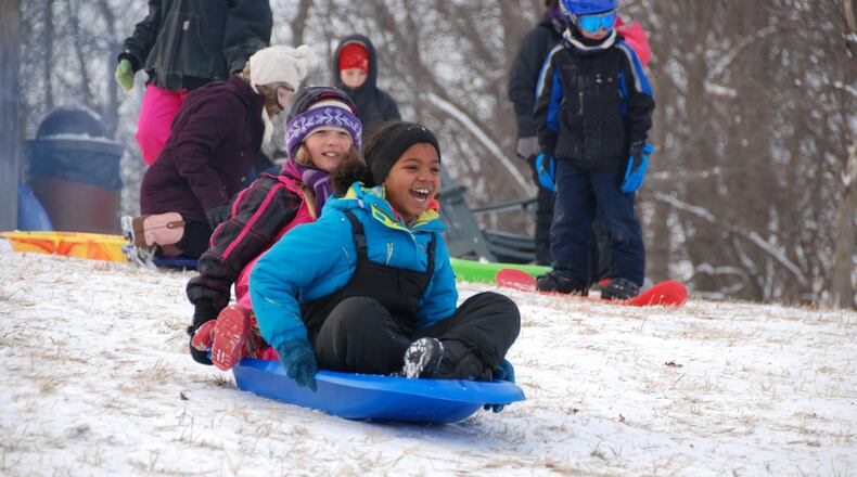 Proper winter wear can make an afternoon of sledding more fun. These young sledders enjoy Taylorsville MetroPark. AMY FORSTHOEFEL/CONTRIBUTED