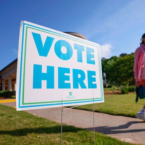 A person walks past a voting sign during the first day of early voting for the primary elections at the Dunwoody Library in Atlanta, Monday, April 27, 2026. (Miguel Martinez/Atlanta Journal-Constitution via AP)