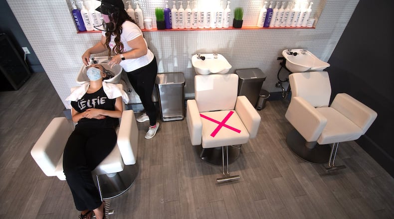 Blo Blow Dry Bar district manager Maria Dowling works on Sara Askari’s hair at the Buckhead location Thursday, July 2, 2020. STEVE SCHAEFER FOR THE ATLANTA JOURNAL-CONSTITUTION