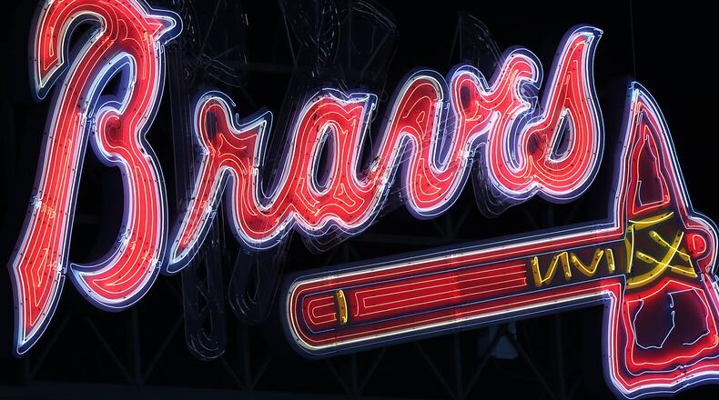 The Braves’ neon logo lights the night sky over Turner Field late last season. Curtis Compton /ccompton@ajc.com