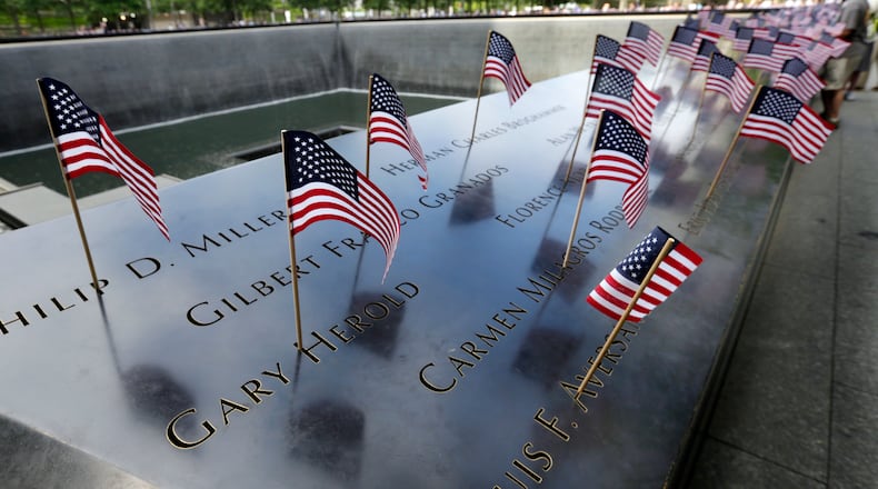 American flags were inserted in each of the 2,983 names on the 9/11 Memorial, in New York, Tuesday, July 4, 2017. (AP Photo/Richard Drew)