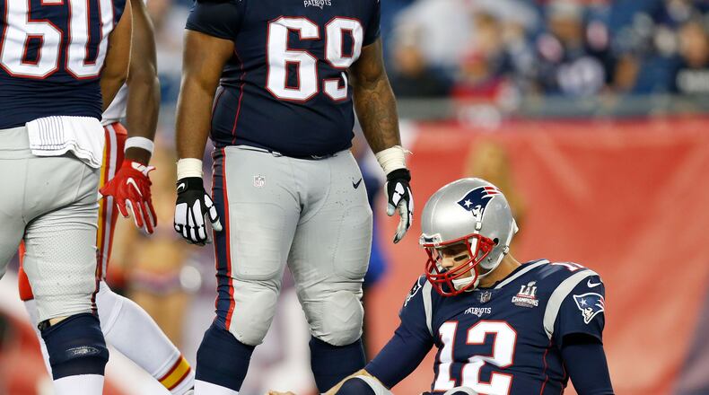 New England Patriots quarterback Tom Brady (12) lies on the field after being sacked in the fourth quarter against the Kansas City Chiefs at Gillette Stadium.
