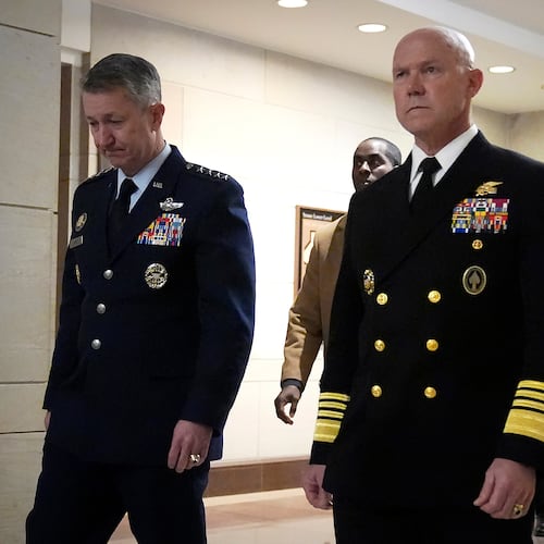 U.S. Navy Adm. Frank M. Bradley, right, accompanied by Gen. Dan Caine, chairman of the Joint Chiefs of Staff, left, walks to a meeting with senators on Capitol Hill, Thursday, Dec. 4, 2025, in Washington. (AP Photo/Mark Schiefelbein)