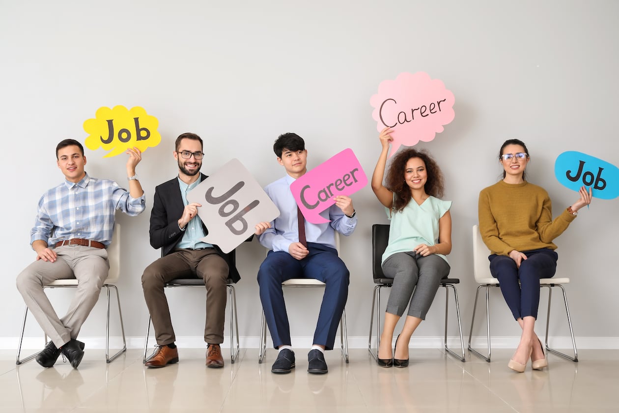 Young people holding speech bubbles with words JOB and CAREER indoors. For TWP story about careers and jobs. 081725 CREDIT ADOBE STOCK