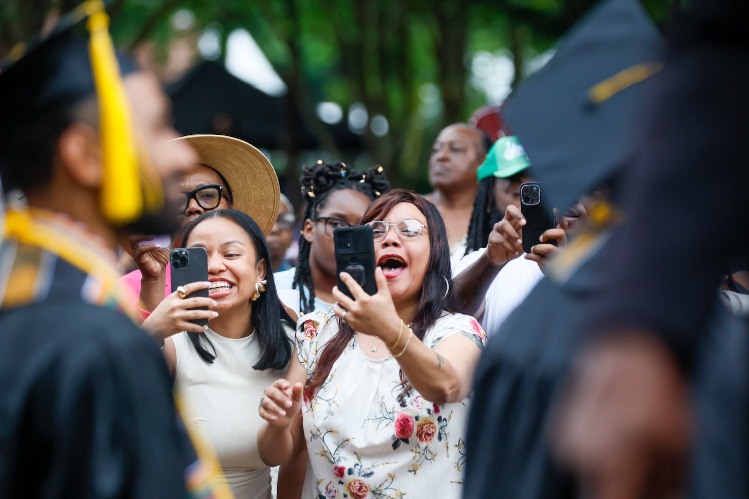A family member wears a headband as they watch the graduate enter the ceremony during Morehouse College's 141st Commencement Ceremony on Sunday, May 18, 2025.
(Miguel Martinez/ AJC)