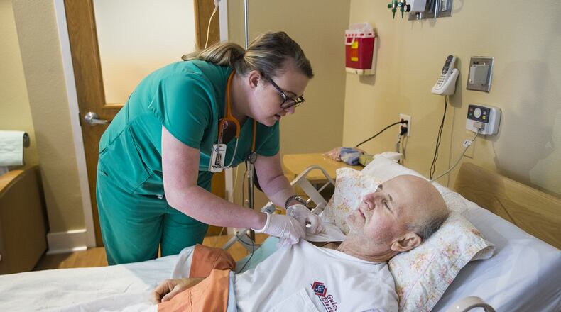 The state Nursing Board represents by far the largest number of professionals while operating with a regulatory staff that reports to Georgia Secretary of State Brian Kemp. Investigations there take at least half a year on average, while the accused nurse may still be licensed to work and under no public warning or private monitoring. In this photo, a nurse helps a patient. PHOTO by RICARDO B. BRAZZIELL / AUSTIN AMERICAN-STATESMAN