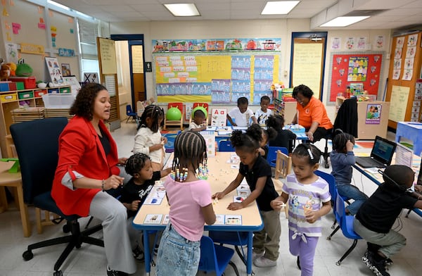Teachers work with pre-K students at the DeKalb Early Learning Center. (Hyosub Shin/AJC)