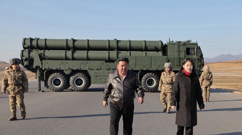 In this photo provided by the North Korean government, its leader Kim Jong Un, with his daughter, believed to be named Kim Ju Ae, inspects test-firing of ballistic missiles from an undisclosed location in North Korea, Tuesday, Jan. 27, 2026. Independent journalists were not given access to cover the event depicted in this image distributed by the North Korean government. The content of this image is as provided and cannot be independently verified. Korean language watermark on image as provided by source reads: "KCNA" which is the abbreviation for Korean Central News Agency. (Korean Central News Agency/Korea News Service via AP)