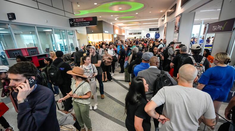 Airline passengers wait in long lines to get through the TSA security screening at William P. Hobby Airport in Houston, Sunday, March 8, 2026. (Brett Coomer/Houston Chronicle via AP)