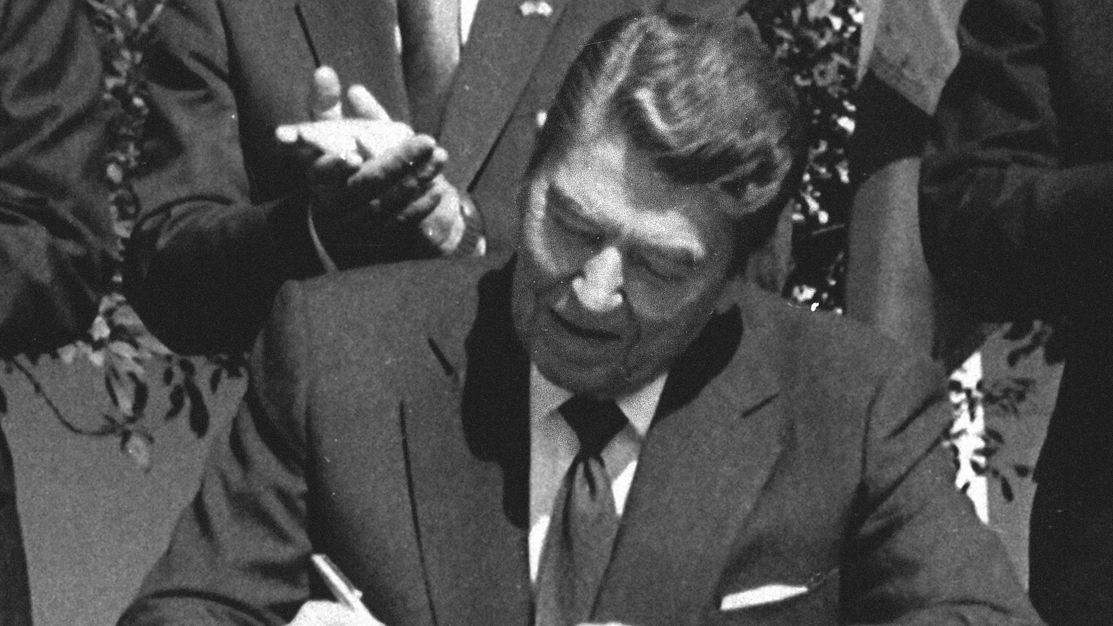 FILE - President Ronald Reagan signs legislation implementing the U.S.-Canada free trade agreement during a ceremony at the White House, Sept. 28, 1988. (AP Photo/Scott Stewart, File)