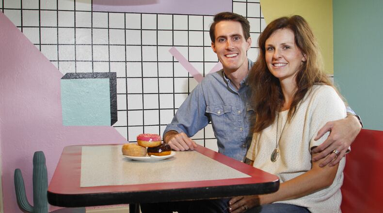 Owners Jeremy and Kelsey Turner sit at the dining table in The McFly house listed on Airbnb. They decorated the home in all 80’s decor. (Brian Elledge/The Dallas Morning News/TNS)