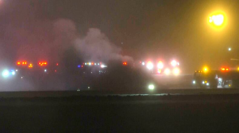 This image taken from video provided by WABI television, emergency cervices work on a scene of the Bombardier Challenger 600 crash at the Bangor Airport in Maine, late Sunday, Jan. 25, 2026. (WABI via AP)