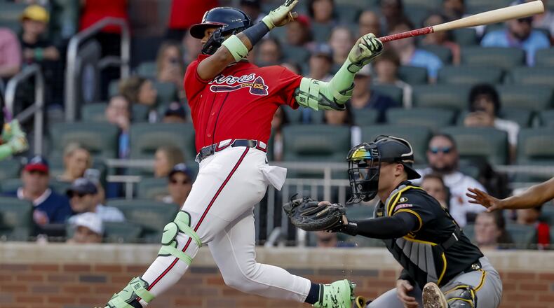 Atlanta Braves' Ronald Acuna Jr., left, hits an RBI single as Pittsburgh Pirates catcher Henry Davis, right looks on during the second inning of a baseball game, Friday, June 5, 2026, in Atlanta. (AP Photo/Erik S. Lesser)