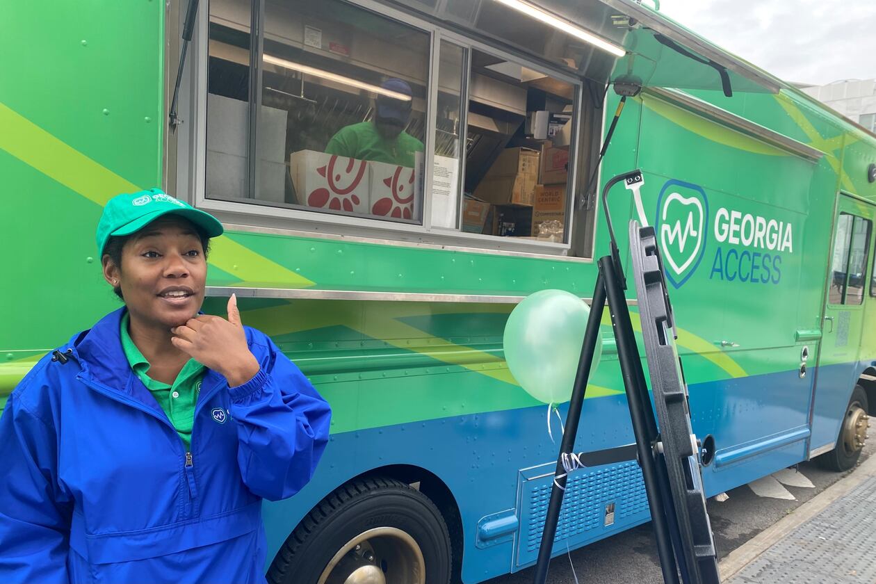 GeorgiaAccess.gov outreach workers like Sheena Wiley travel the state handing out promotional materials for people who might be eligible for health insurance. The truck behind Wiley serves tea and coffee. Georgia Access is the state-based exchange marketplace for the Affordable Care Act in Georgia. (Ariel Hart/AJC 2024)